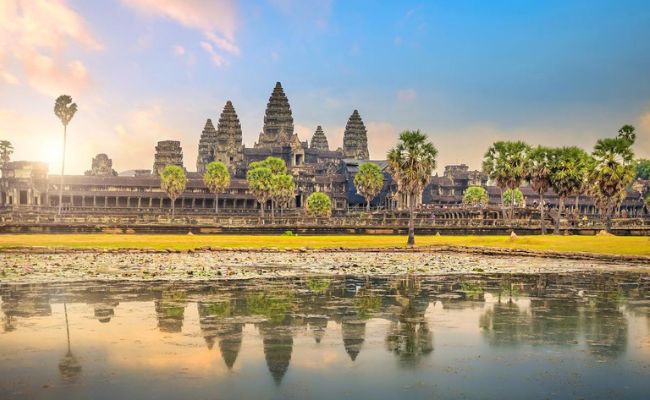 Angkor Wat temple towers reflecting perfectly in the lotus pond during a comprehensive multi day complex adventure tour in Siem Reap.