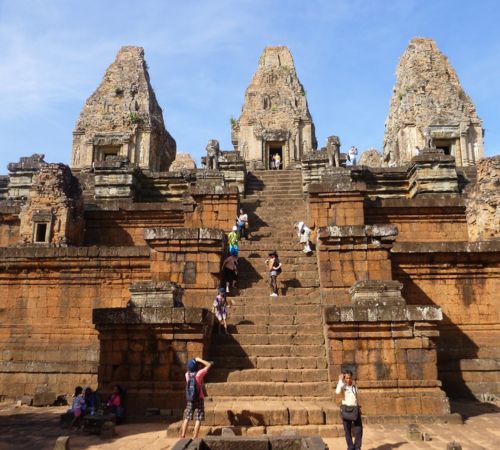Tourists climbing the steep stone steps of Pre Rup temple mountain near Blanc Smith Hotel in Siem Reap.