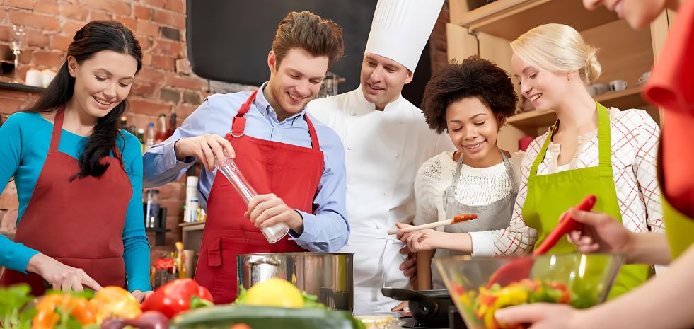 Tourists preparing fresh ingredients and chopping vegetables during a cooking class near Blanc Smith Hotel in Siem Reap.
