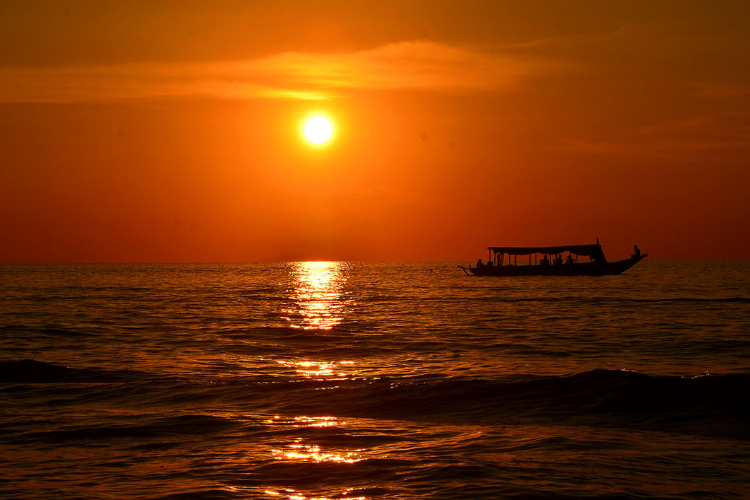 A dramatic orange and golden sunset over Tonle Sap Lake, a popular evening attraction near Blanc Smith Hotel.