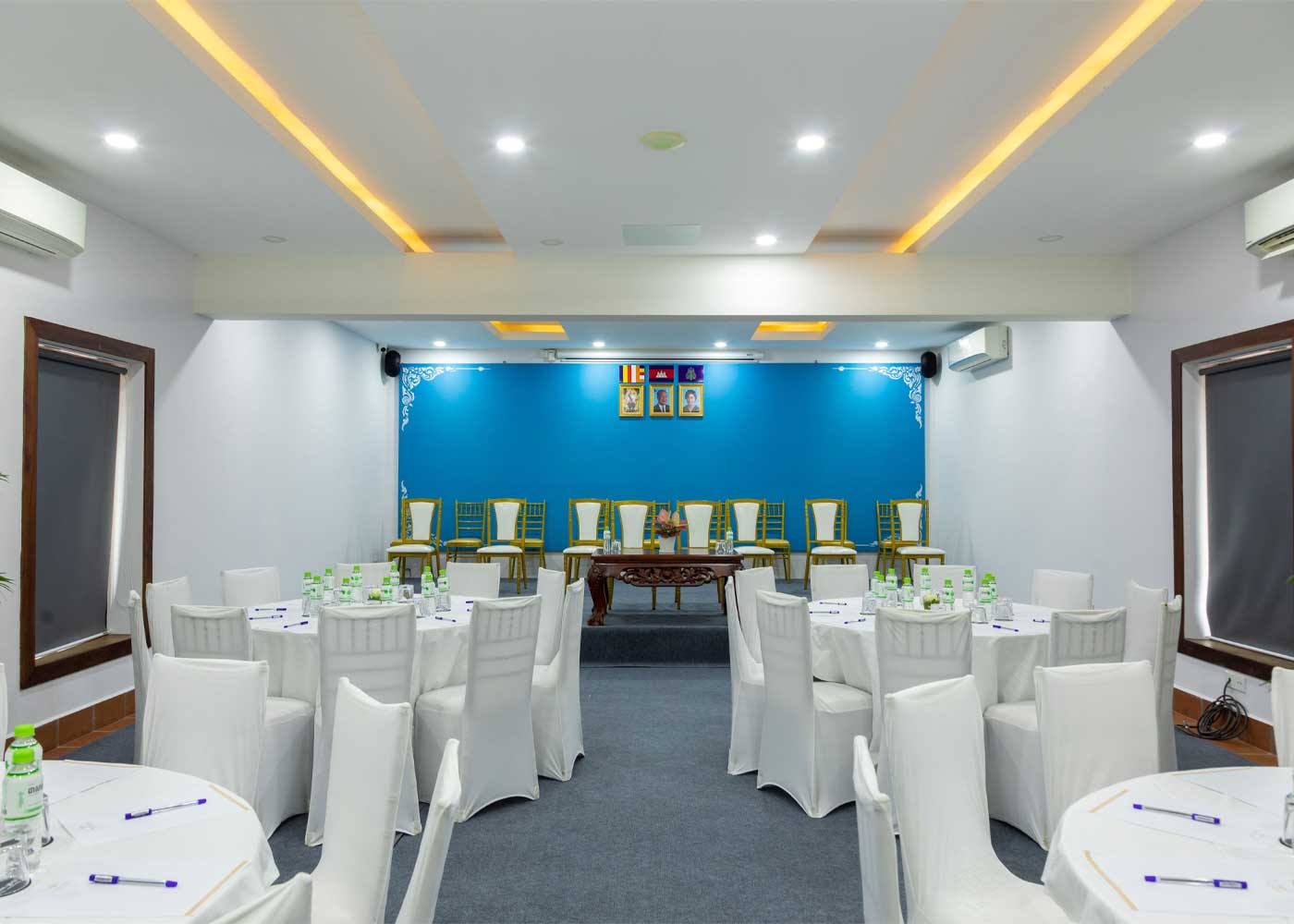 Boutique hotel meeting room setup with round banquet tables, white chair covers, and corporate seminar facilities in Siem Reap.