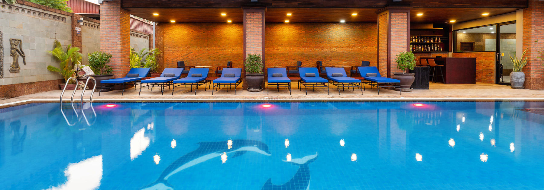 Bright daytime view of outdoor swimming pool and sun loungers at Blanc Smith Hotel in Siem Reap.